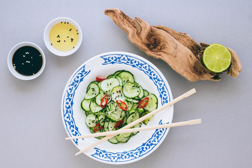 Asian salad and cucumber with sesame seeds, dressed with rice vinegar, lime and sesame oil