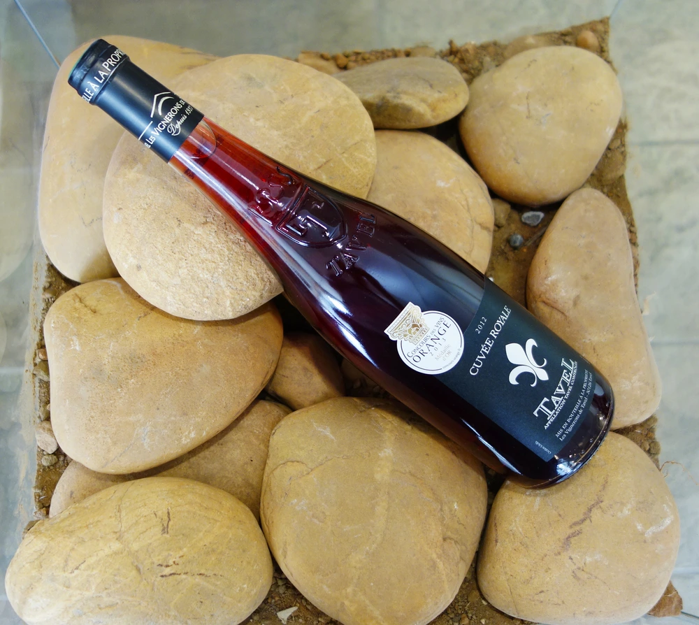 Bottle of Tavel Rose wine sitting on rocks