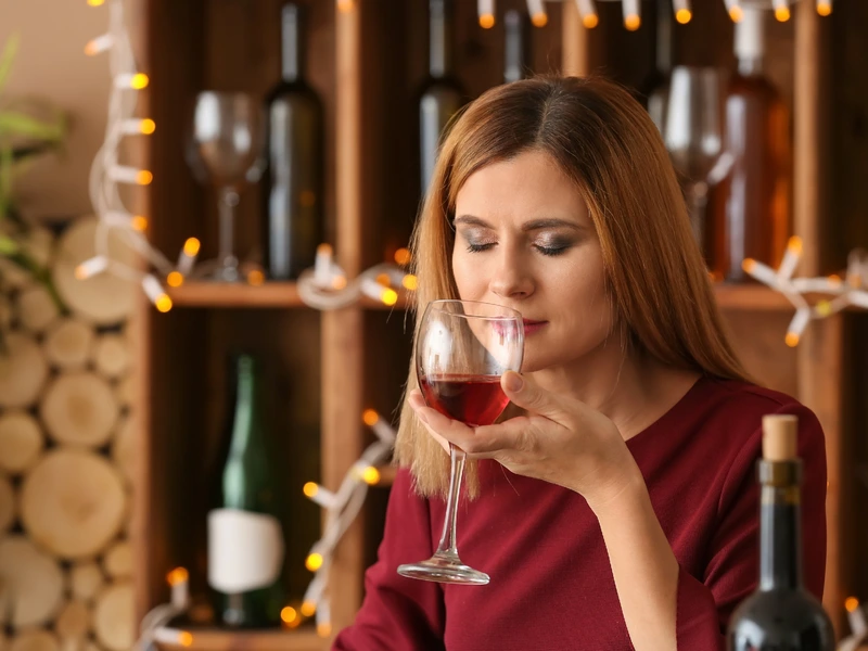 Woman smelling the aroma of red wine during a wine tasting