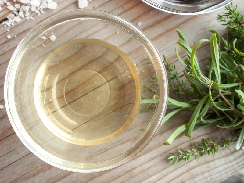 White Wine vinegar in a dish on a wooden table