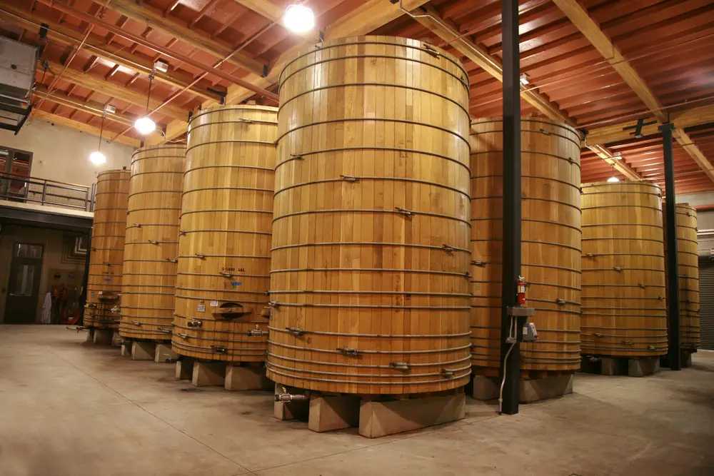 Large oak barrels in a cellar fermenting wine