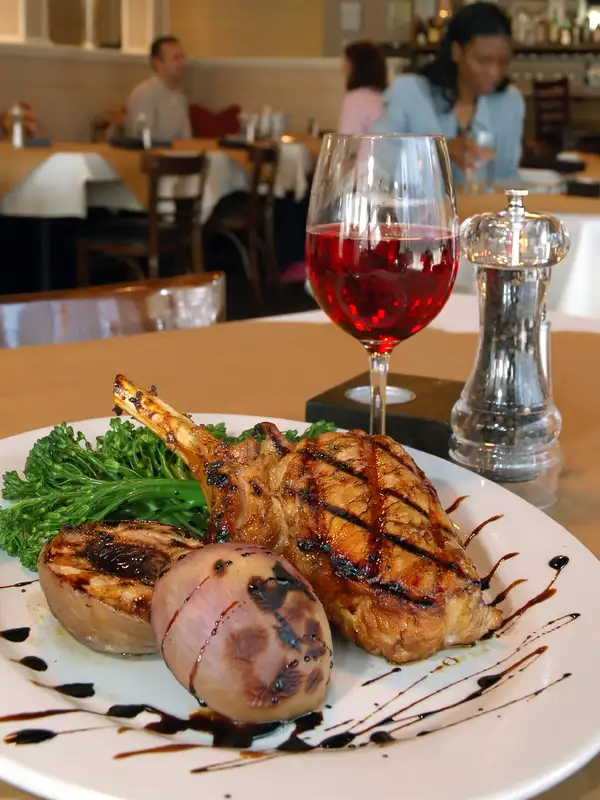 Pork chops and red wine with roast potatoe served in a restaurant