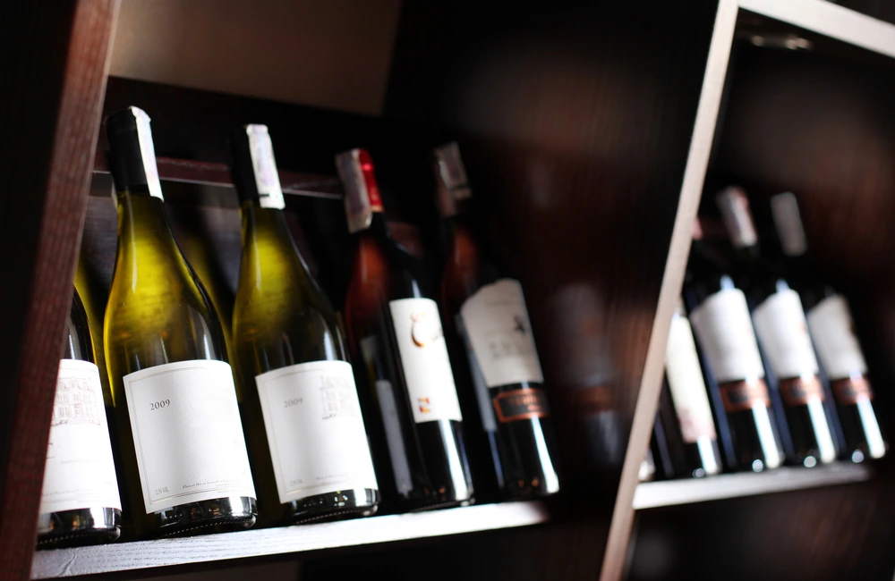 Bottles of wine lined up on a shelf