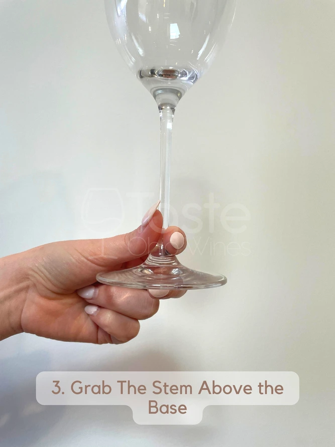 How to Hold a Wine Glass With a Stem 3. Grab The Stem Above the Base