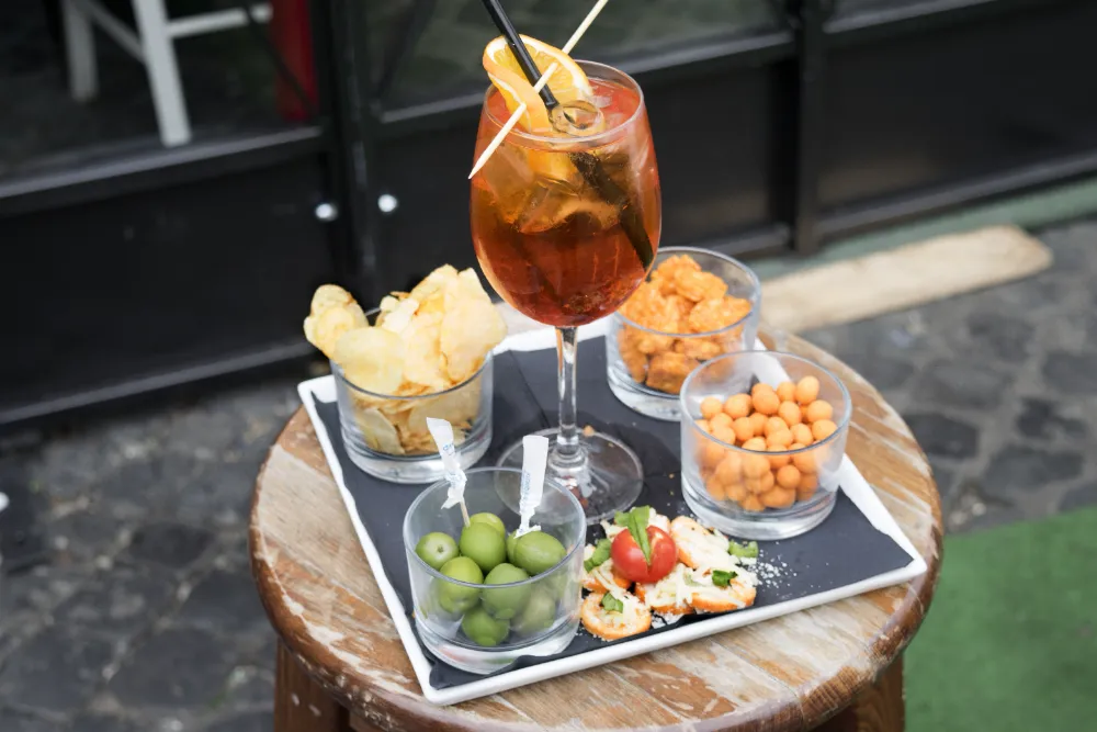 Aperitif wine with olives, nuts and chips