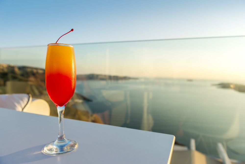 Tequila Sunrise Cocktail overlooking the sea