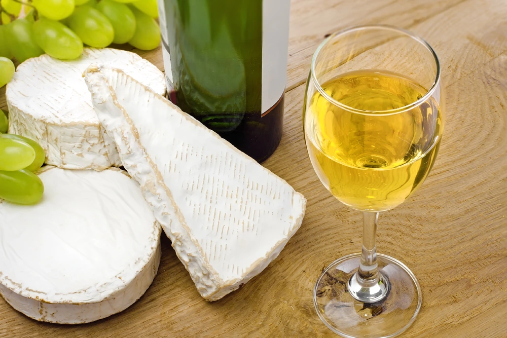 White wine, served with Brie, Camembert and grape