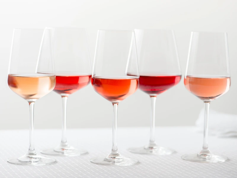 Rose Wine In glasses in a row on white background