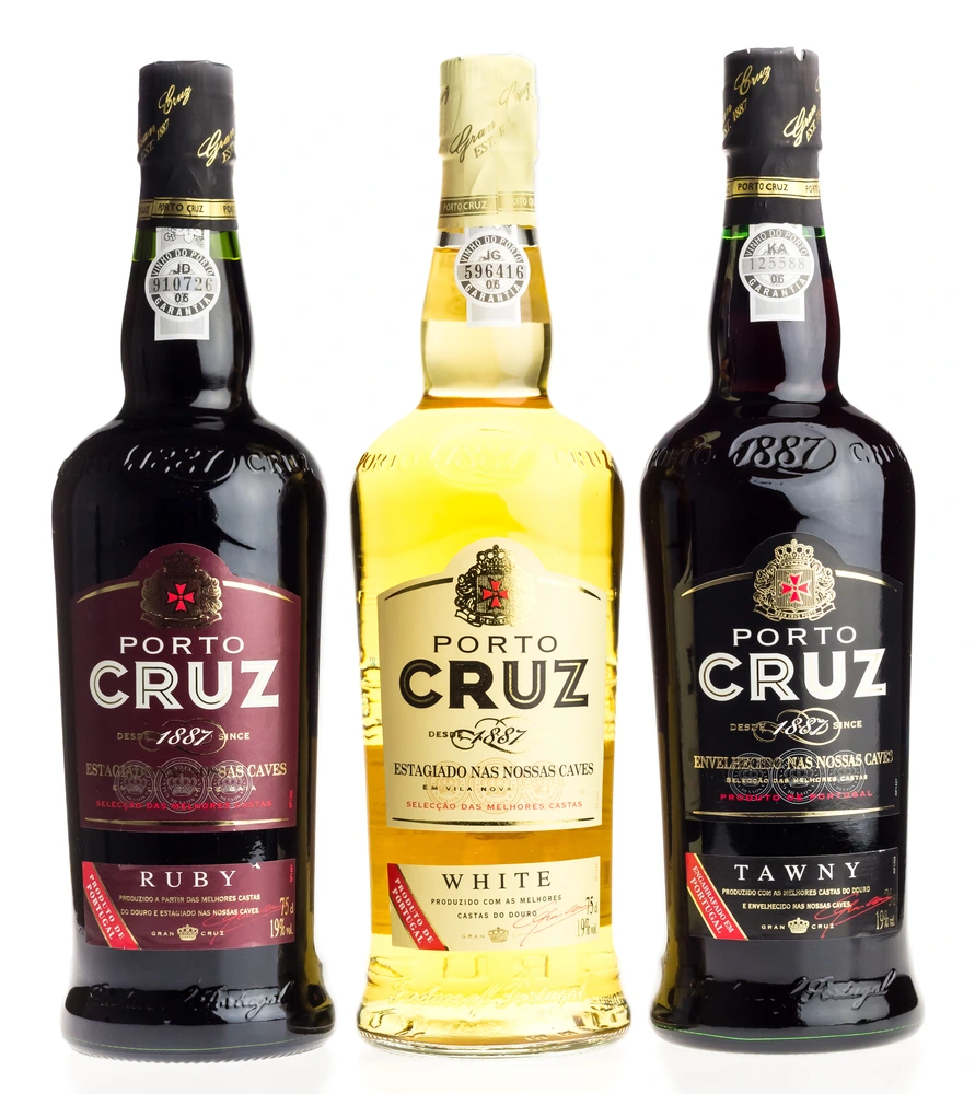 Bottles of Portugese Cruz White, Red and tawny Port on a white background