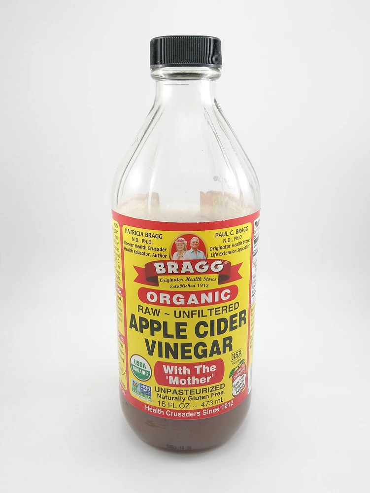 Bragg Apple cider vinegar with the 'Mother' bottle on a white background