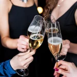 Women clinking brut and extra dry champagne
