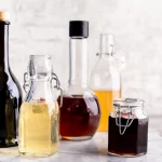Different vinegar bottles lined up on a white background