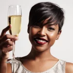 Beautiful black woman with a glass of Champagne