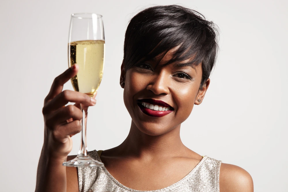 Beautiful black woman with a glass of Champagne