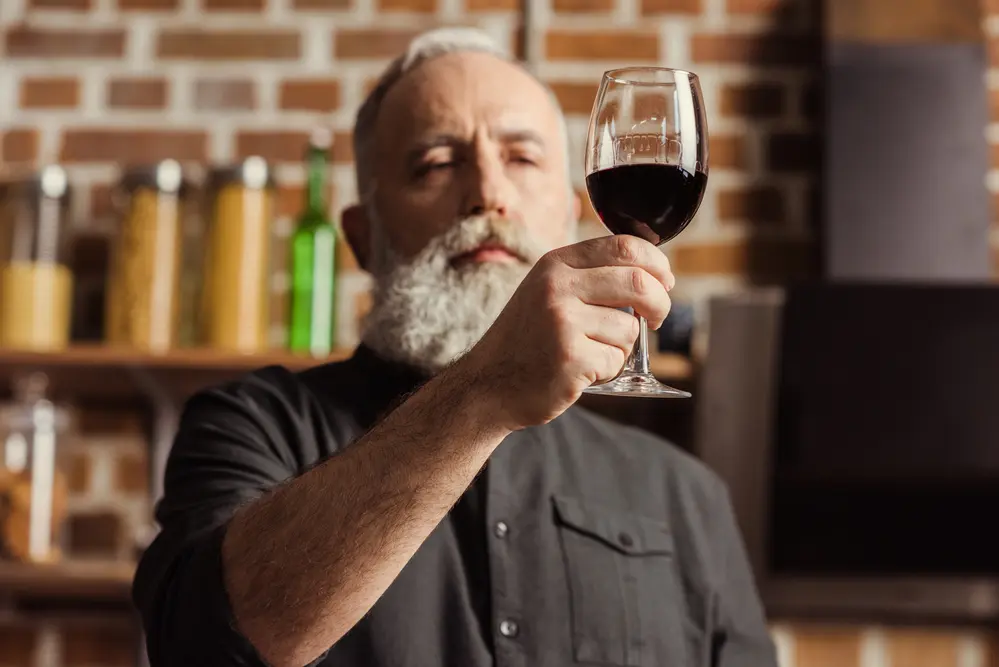 Man examining a full body red wine alcohol levels