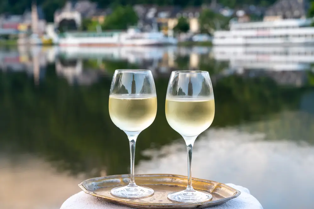 Glasses of Riesling on an outdoor patio beside a river in Germany