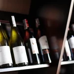 Bottles of wine lined up on a shelf