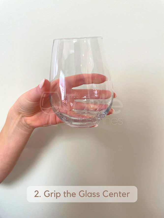 How to Hold a Stemless Wine Glass 2. Grip the Glass Center