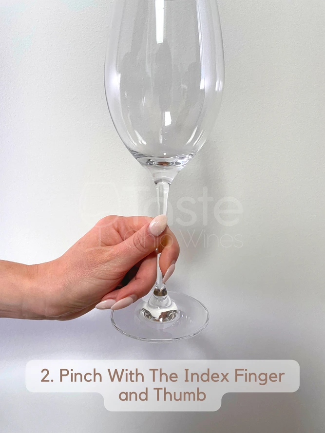 How to Hold a Wine Glass With a Stem 2. Pinch With The Index Finger and Thumb