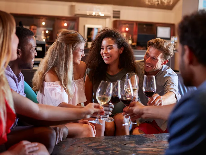 Which wines are best for someone who gets acid reflux - People enjoying wine in a bar